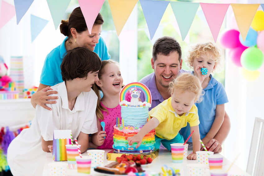 Unicorn birthday decorations: family celebrating a birthday