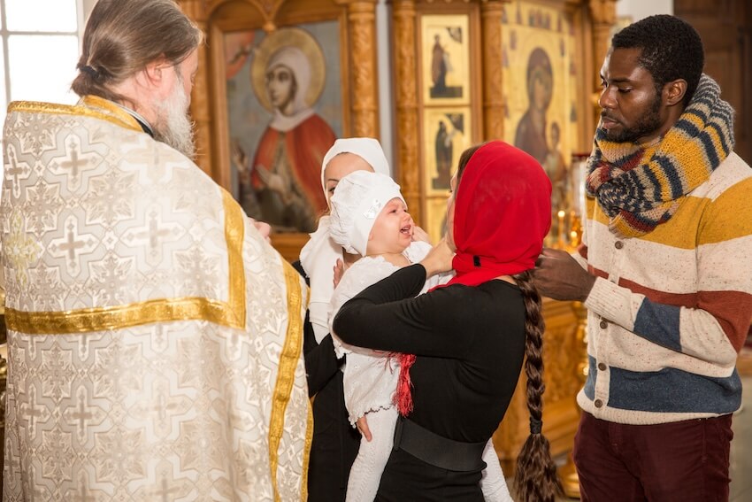 What to write in a baptism card: family celebrating baptism