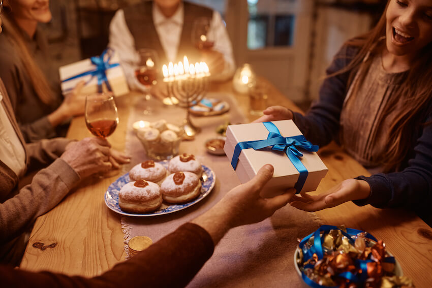 Hanukkah greetings: family happily celebrating Hanukkah at home