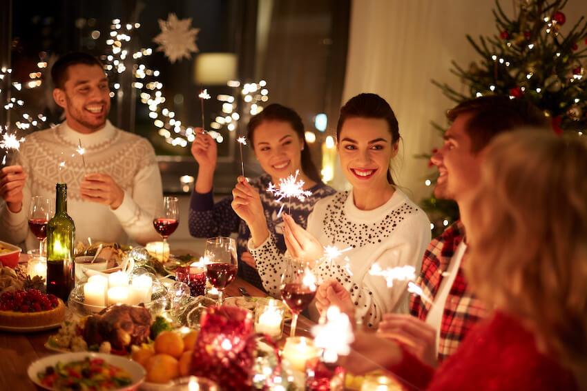 Merry Christmas wishes for friends: family holding some sparklers and celebrating Christmas