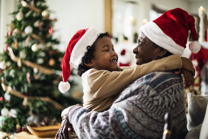 Happy holidays quotes: father and son wearing Santa hats