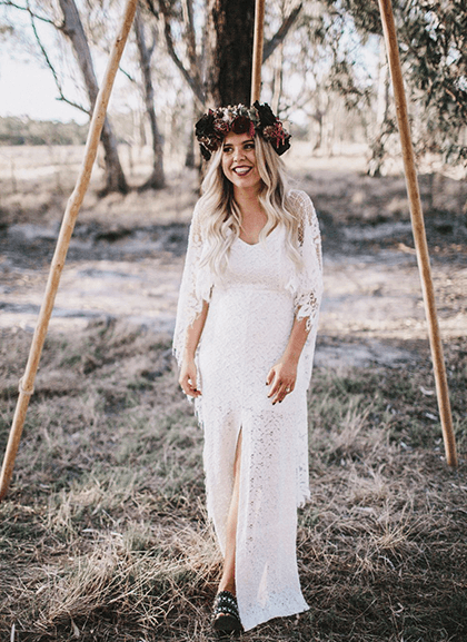 Smiling bride with deep red floral crown