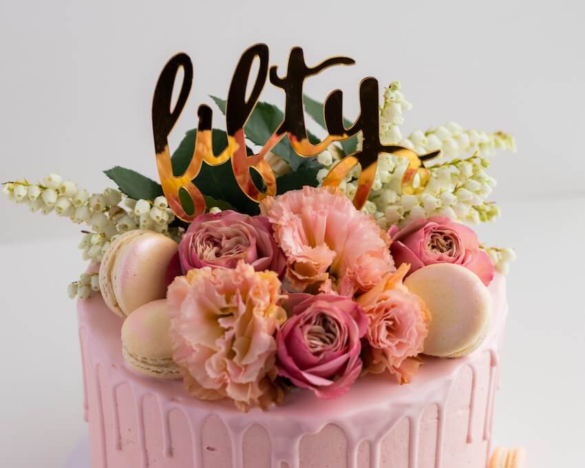 Happy 50th birthday wishes: flowers on top of a birthday cake