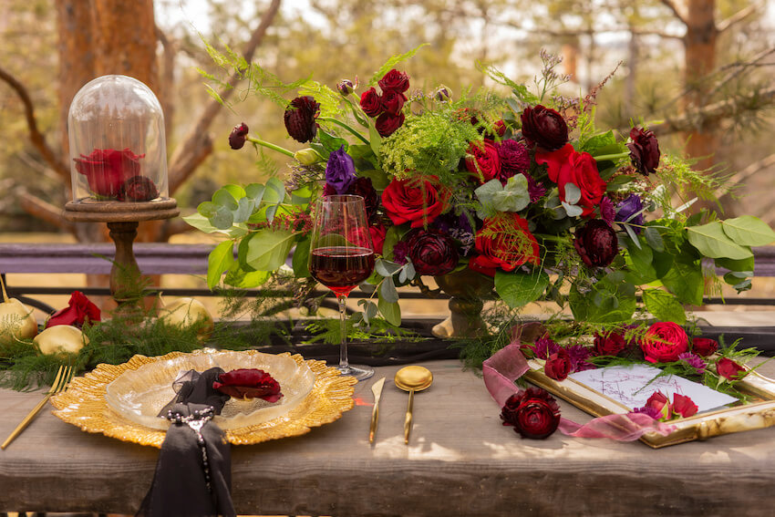 Flowers, wine and a plate on a table