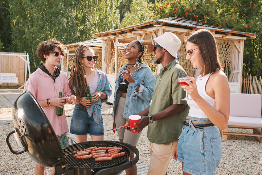 BBQ party: friends drinking while grilling outside