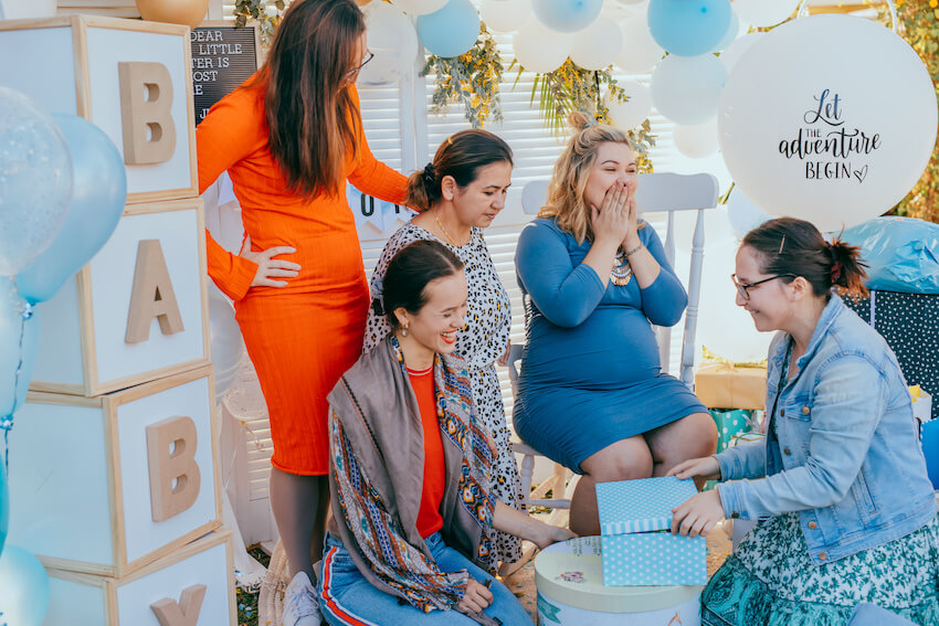 Places to have a baby shower: friends happily celebrating a baby shower