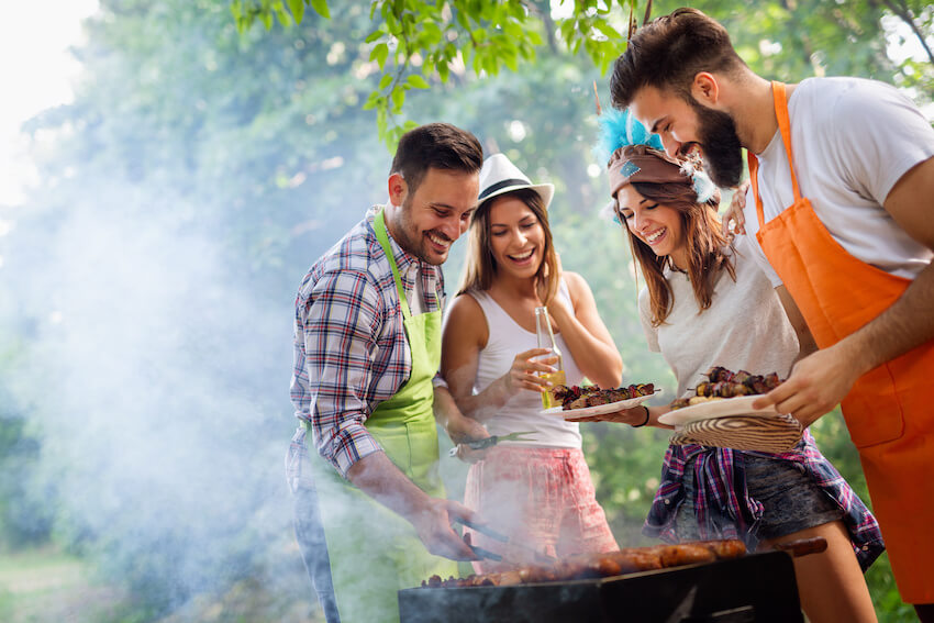 Summer BBQ: friends happily grilling outside
