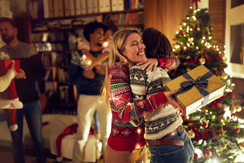 How does secret Santa work: friends hugging each other