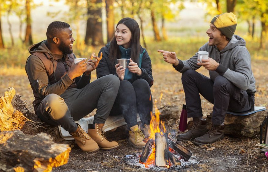 Friends sitting around a campfire