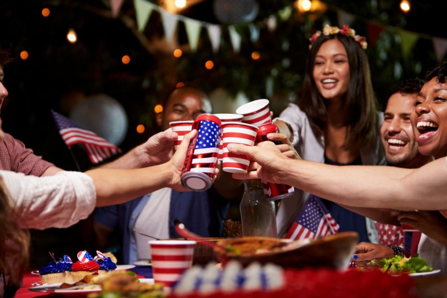 groups of friends toasting at a 4th of July party