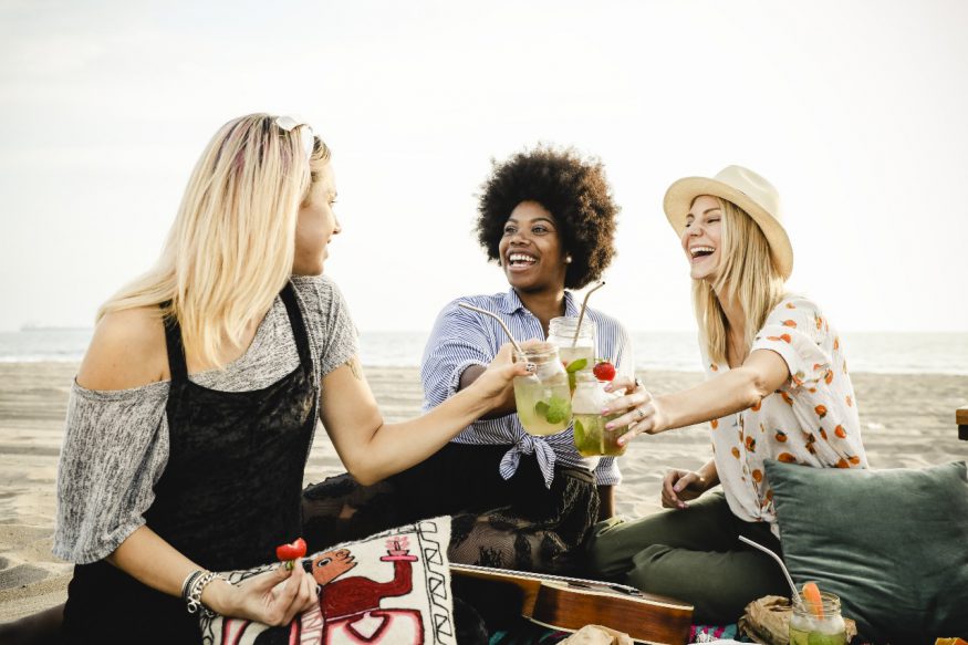 beach party ideas: friends toasting at the beach