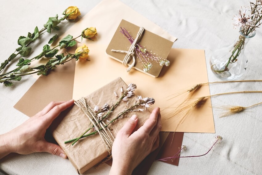 Gifts wrapped in brown paper with dried flowers