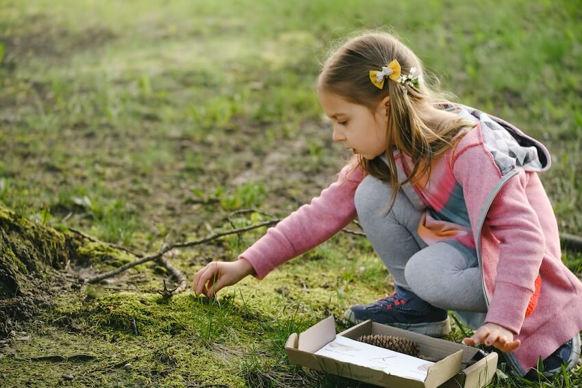 Birthday scavenger hunt: girl enjoying a nature scavenger hunt