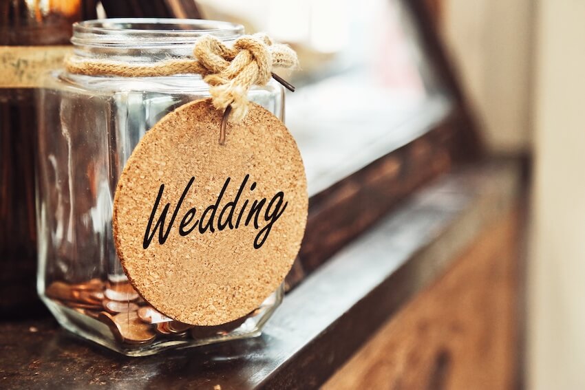 Wedding budget breakdown: mason jar with coins for a wedding