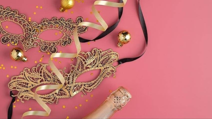 Masquerade party ideas: gold masks on a pink background