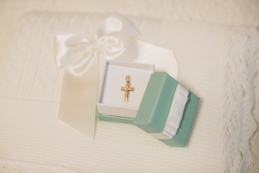 Golden cross pendant in a small box
