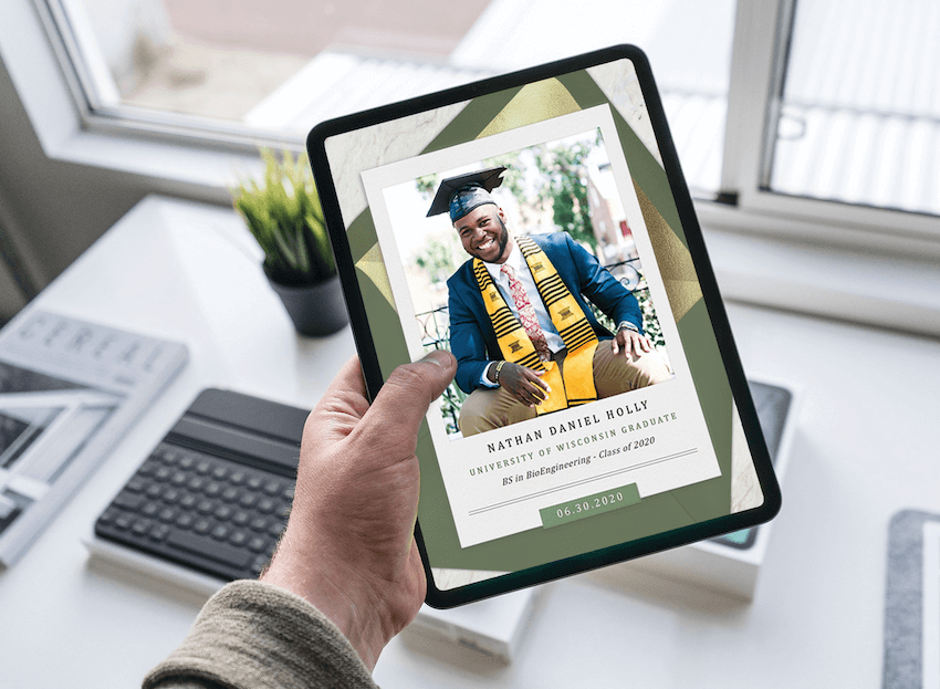 A hand holds a tablet with a college graduation announcement on the screen