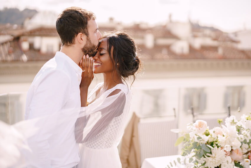 Groom kissing his happy bride