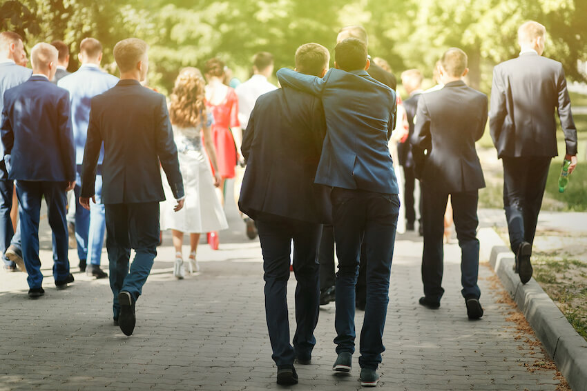 Semi formal wedding: groomsmen walking outside