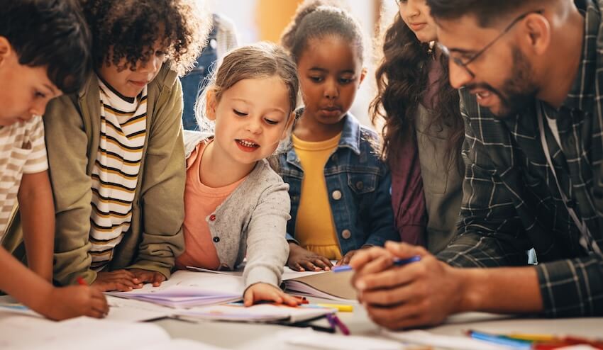 Classroom party ideas: group of children and their teacher gathering around a table