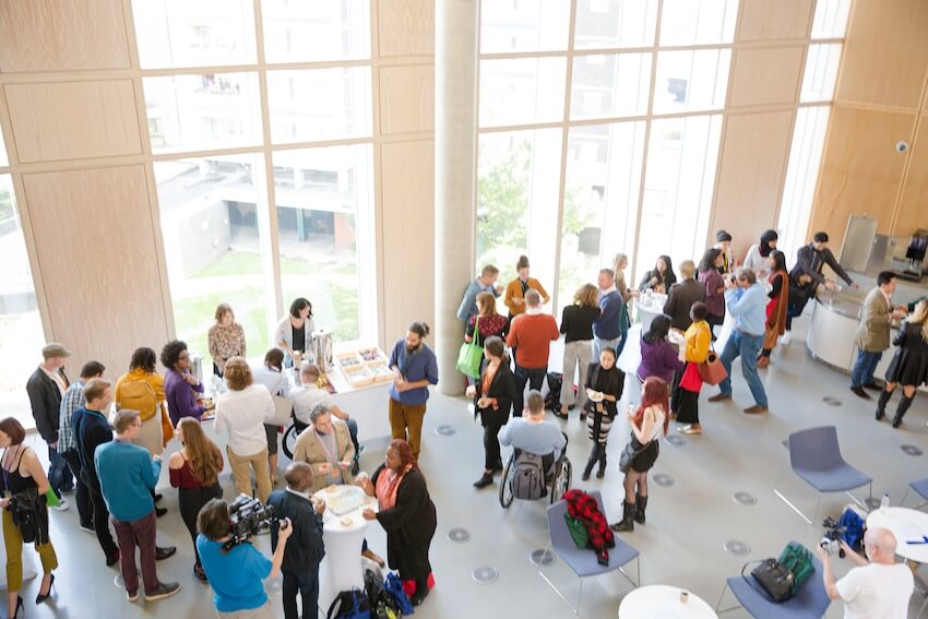 Meet and greet invitation: group of employees in a building