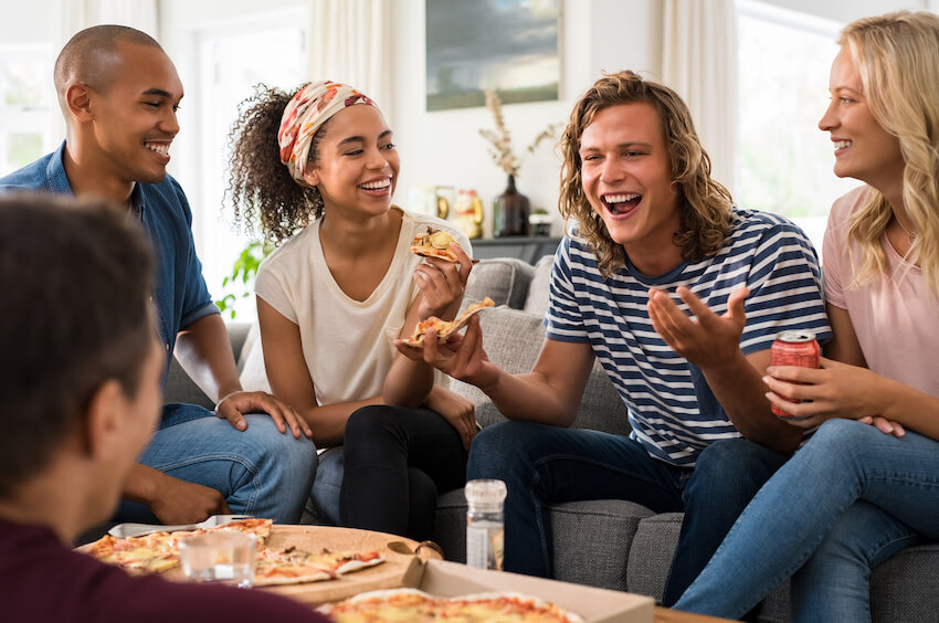 Pizza party: group of friends eating 2 boxes of pizza