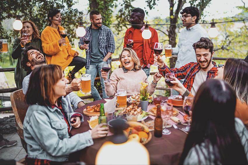 Divorce party ideas: group of friends happily eating and drinking outside