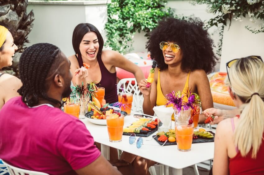 Group of friends happily eating brunch