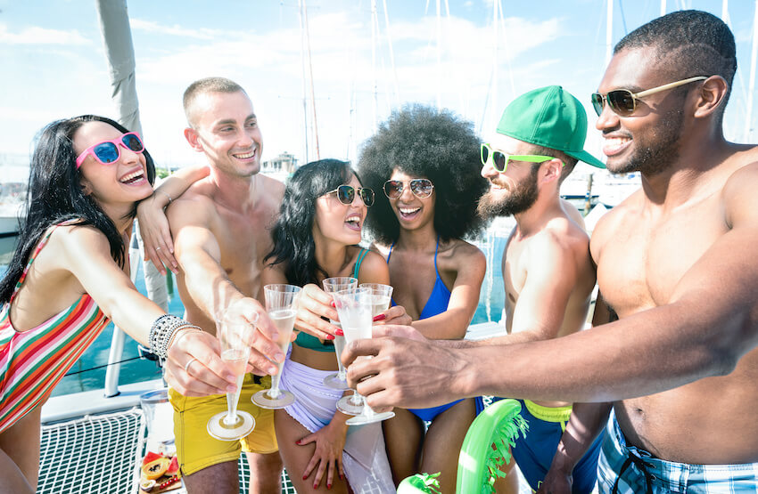 21st birthday party ideas: group of friends having a toast at a beach