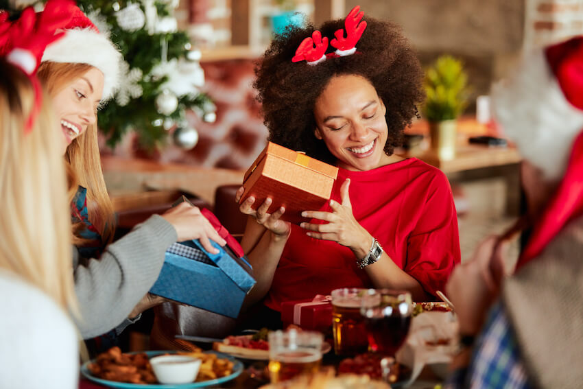 Gift exchange ideas: group of friends opening some Christmas gifts