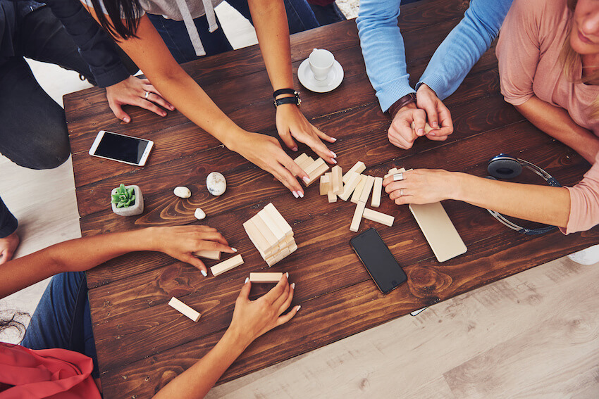 Adult game night: group of friends playing Jenga