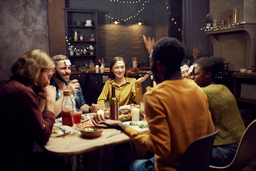 Adult game night: group of friends playing a guessing game