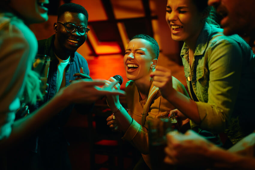 Group of friends singing at a bar