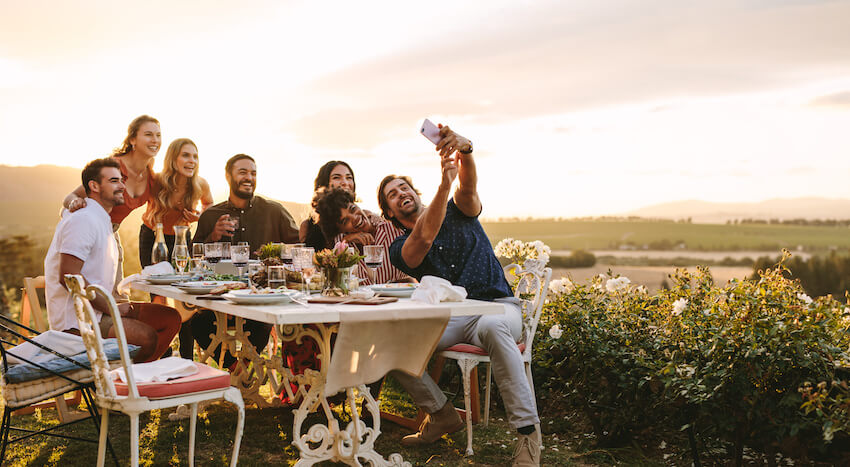 Birthday dinner party ideas: group of friends talking a photo