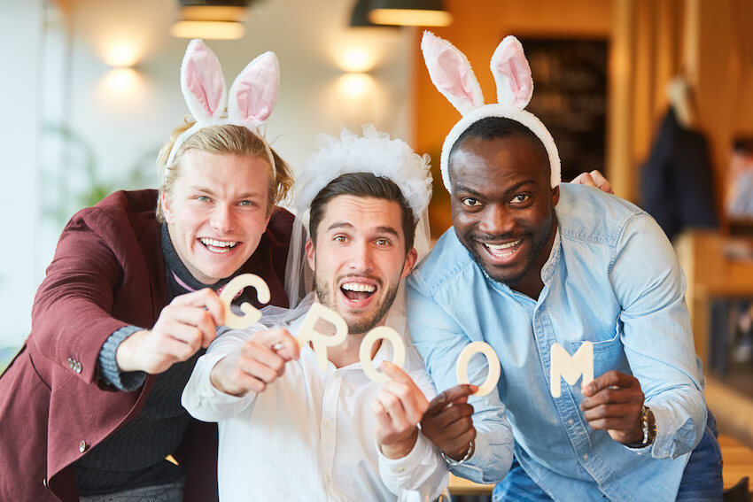 group of happy men celebrating a bachelor party