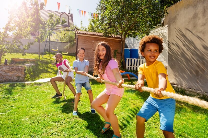 Back to school party ideas: group of kids playing tug of war