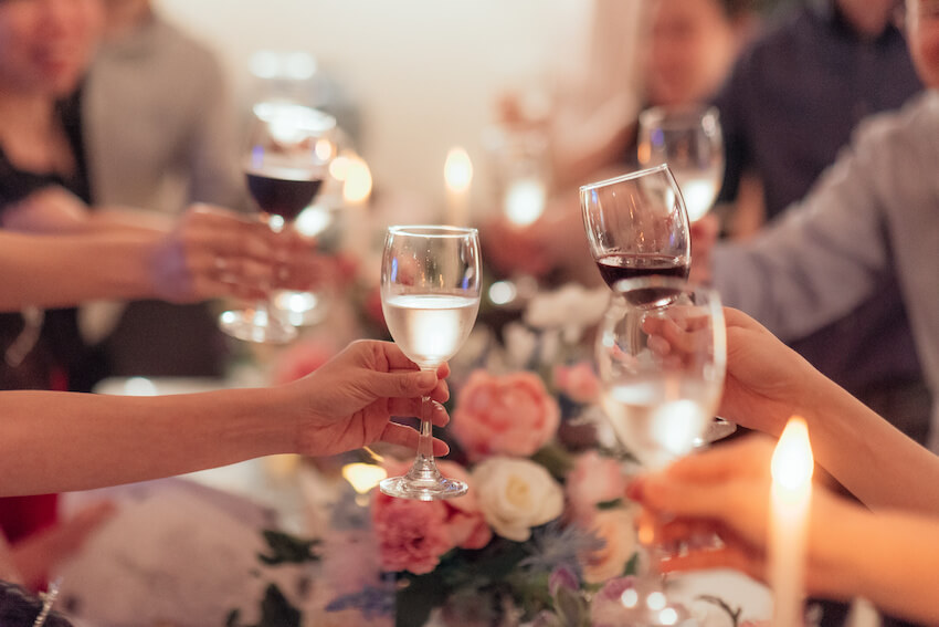 Who goes to the rehearsal dinner: group of people having a toast