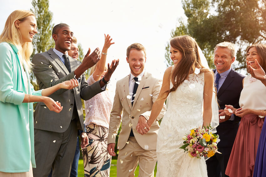 Semi formal wedding: guests throwing confetti in the air