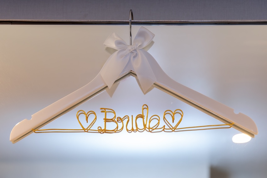 Hanger with a golden wire bent into the word "Bride"
