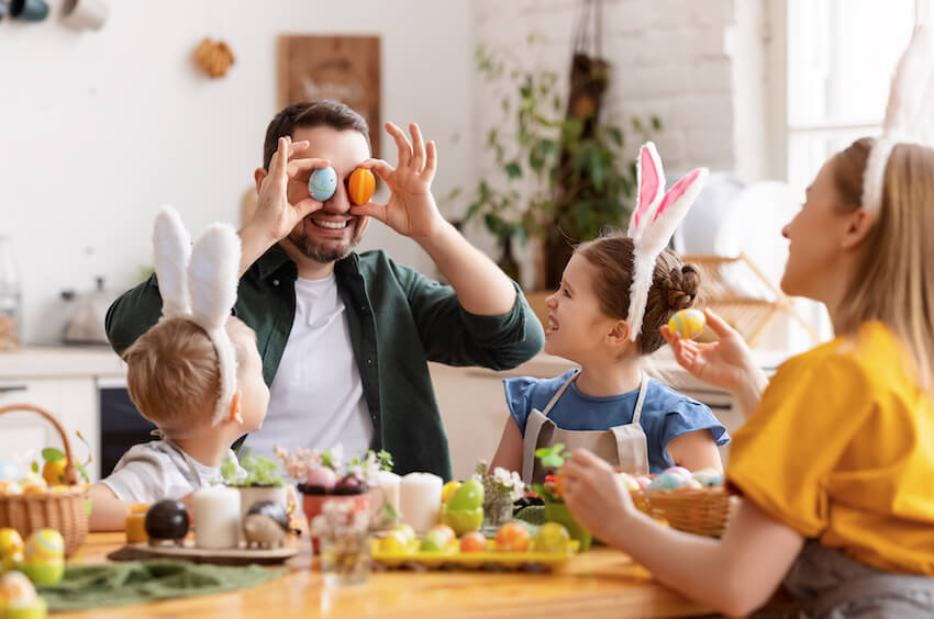 Happy family playing with Easter eggs