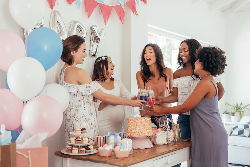 Cute baby shower ideas: happy women toasting a baby shower