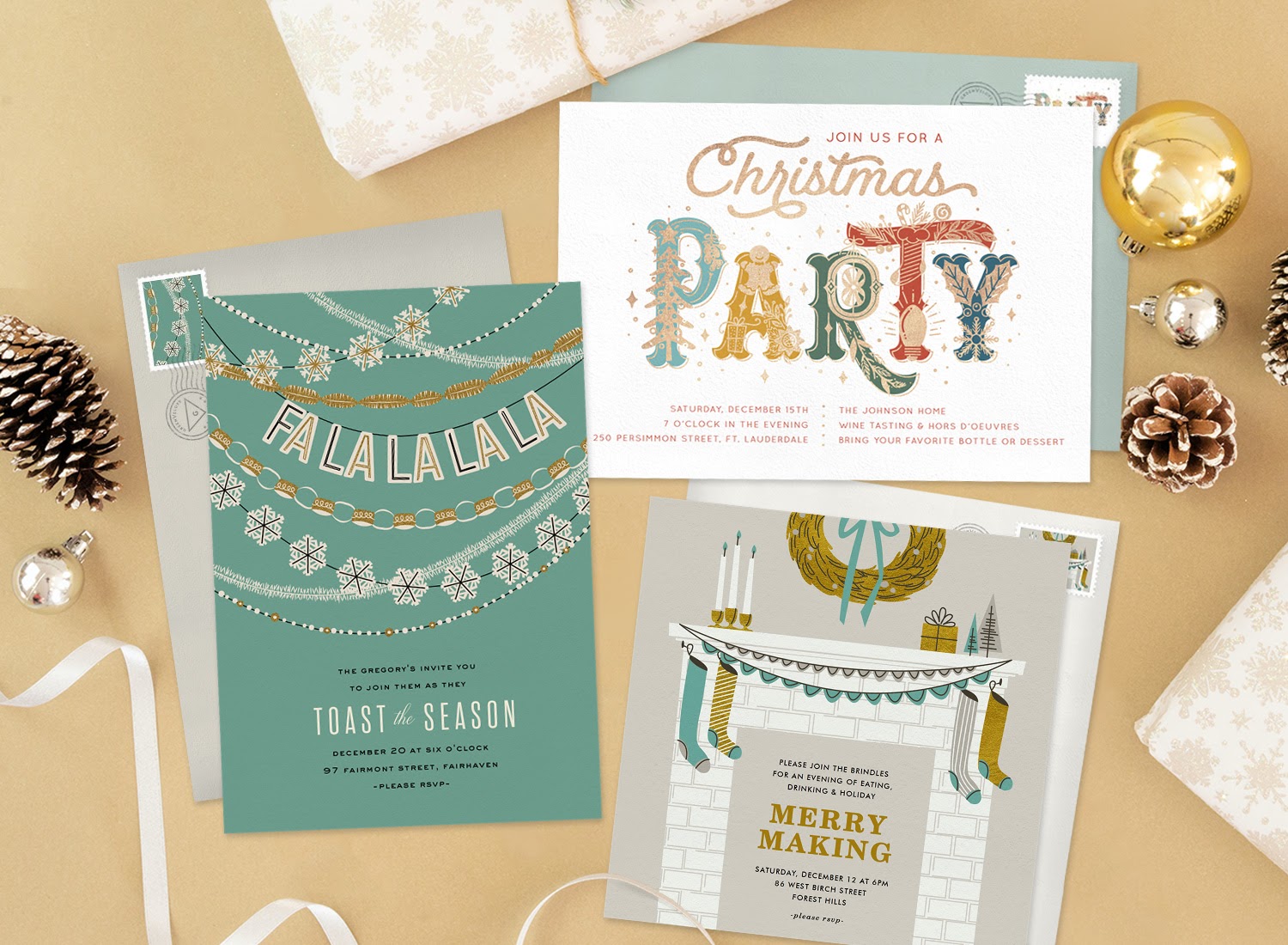 Three holiday party invitations surrounded by ornaments, pine cones, and presents