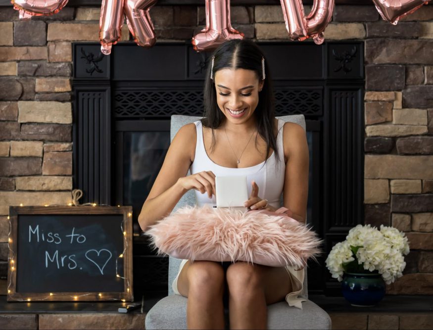 bridal shower gifts: Woman opening a gift at her bridal shower