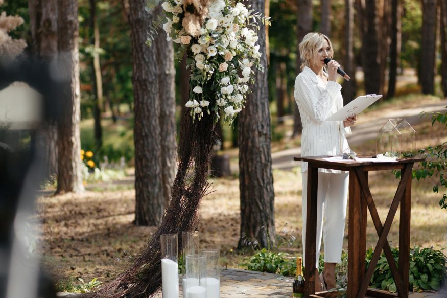 wedding poems: Woman wearing white doing a speech during wedding ceremony