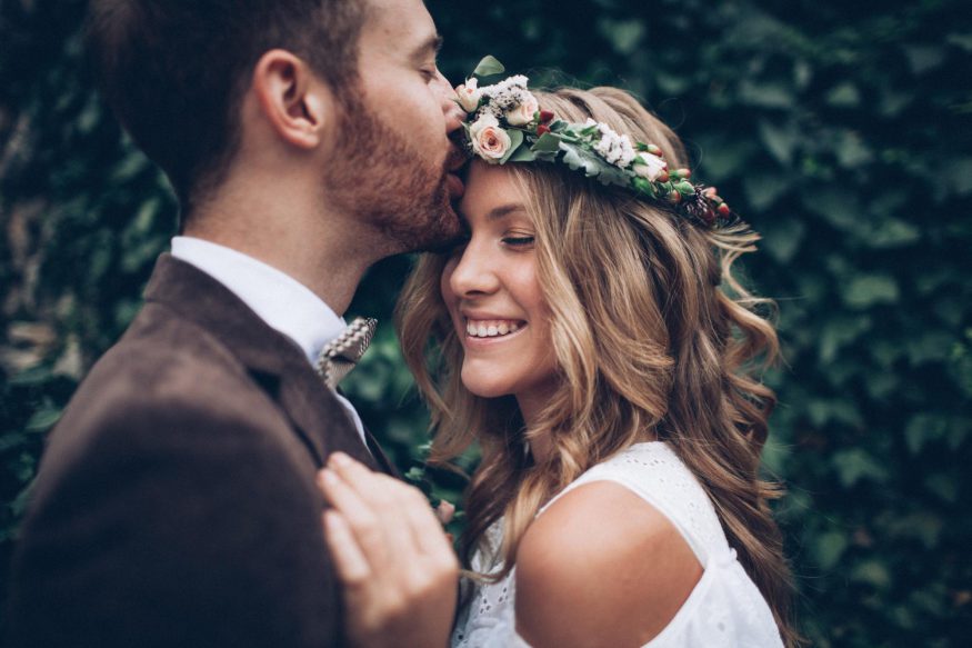 save the date postcards: Groom giving his smiling bride a forehead kiss