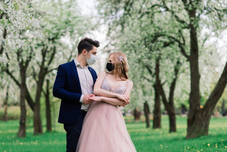 COVID wedding ideas: Wedding couple at the park while wearing masks