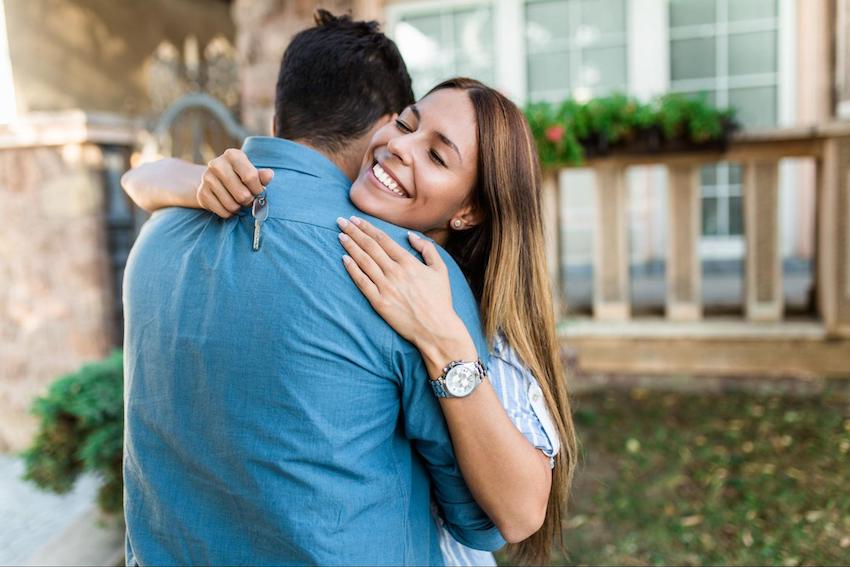 congratulations on your new home: woman hugging a man