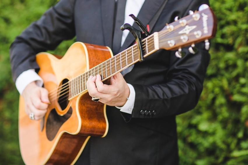 Man in suit playing guitar