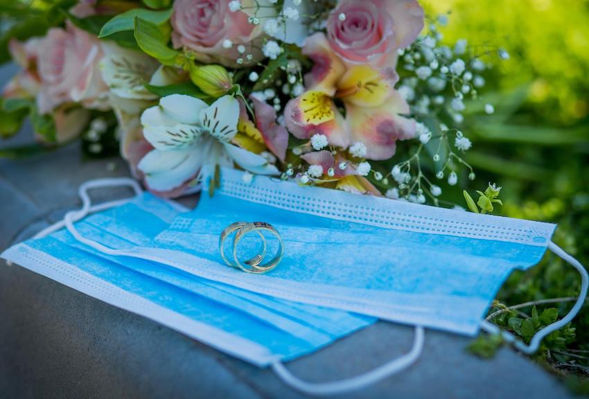 backyard wedding reception: two rings on top of two masks