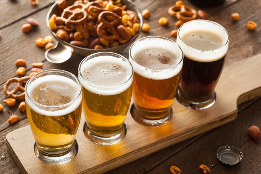 virtual happy hour: Four glasses of beer with a nuts and pretzel mix on the side